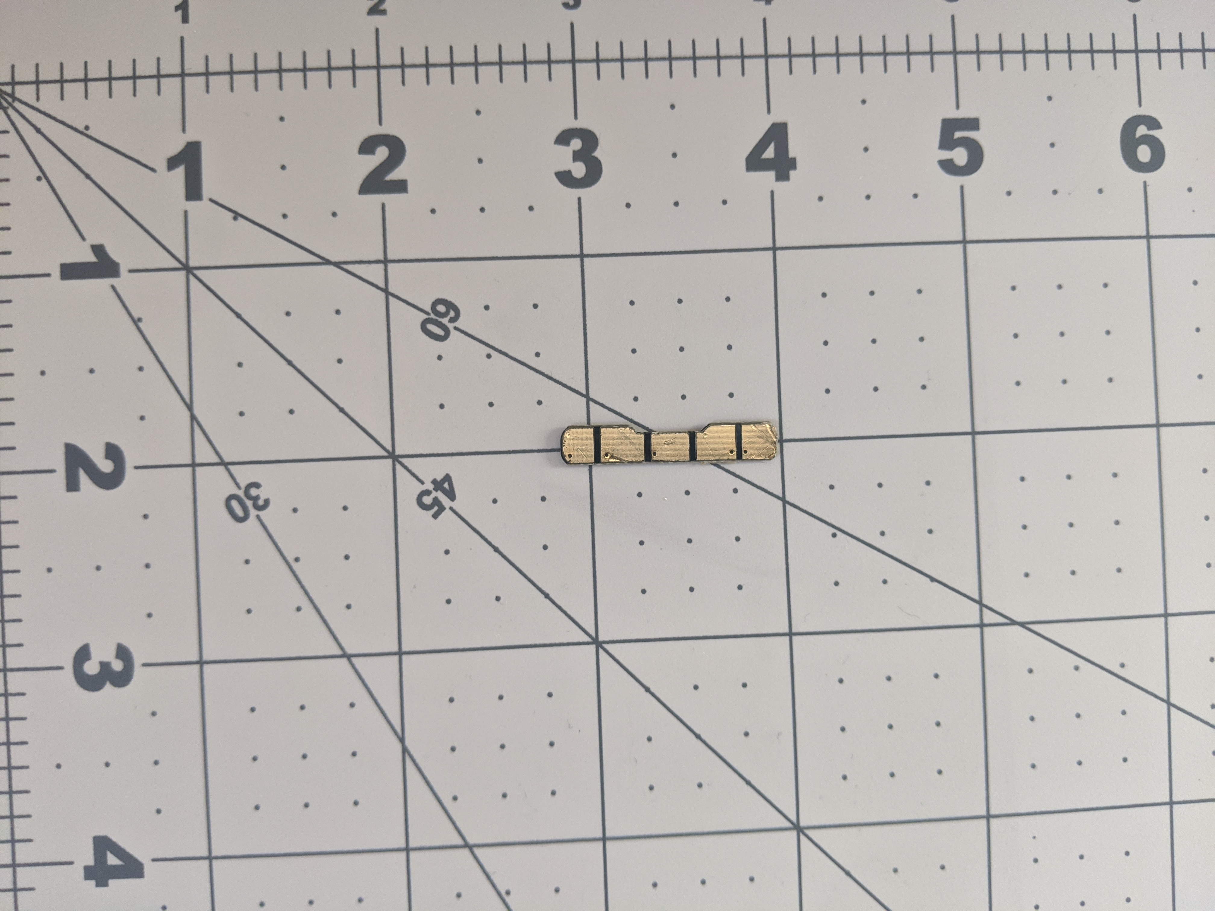 The bottom side of the PCB. It has 5 golden pads that are seperated by a horizontal line.